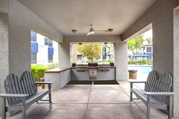 Poolside terrace featuring barbecue pavilion and fire pit